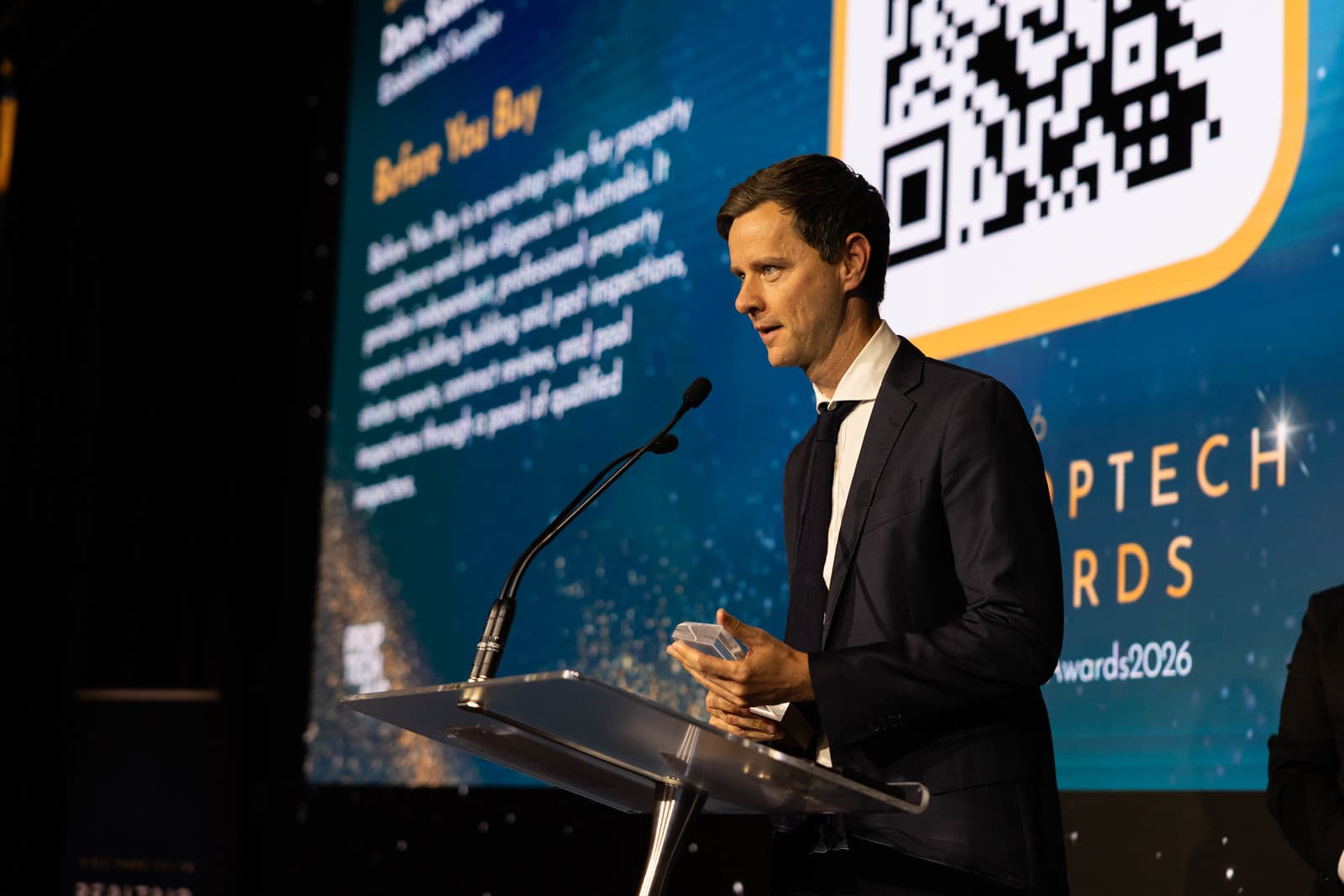 Rhys Rogers, CEO of Before You Buy, accepting a 2026 Proptech Award on stage